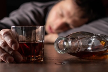 passed-out man with liquor glass