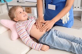 pediatrician examining child with appendicitis