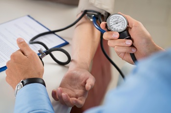 doctor checking blood pressure