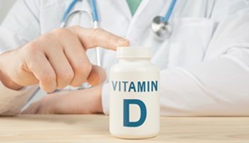 doctor with vitamin D bottle