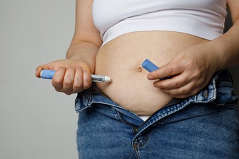 Woman injecting GLP weight-loss drug